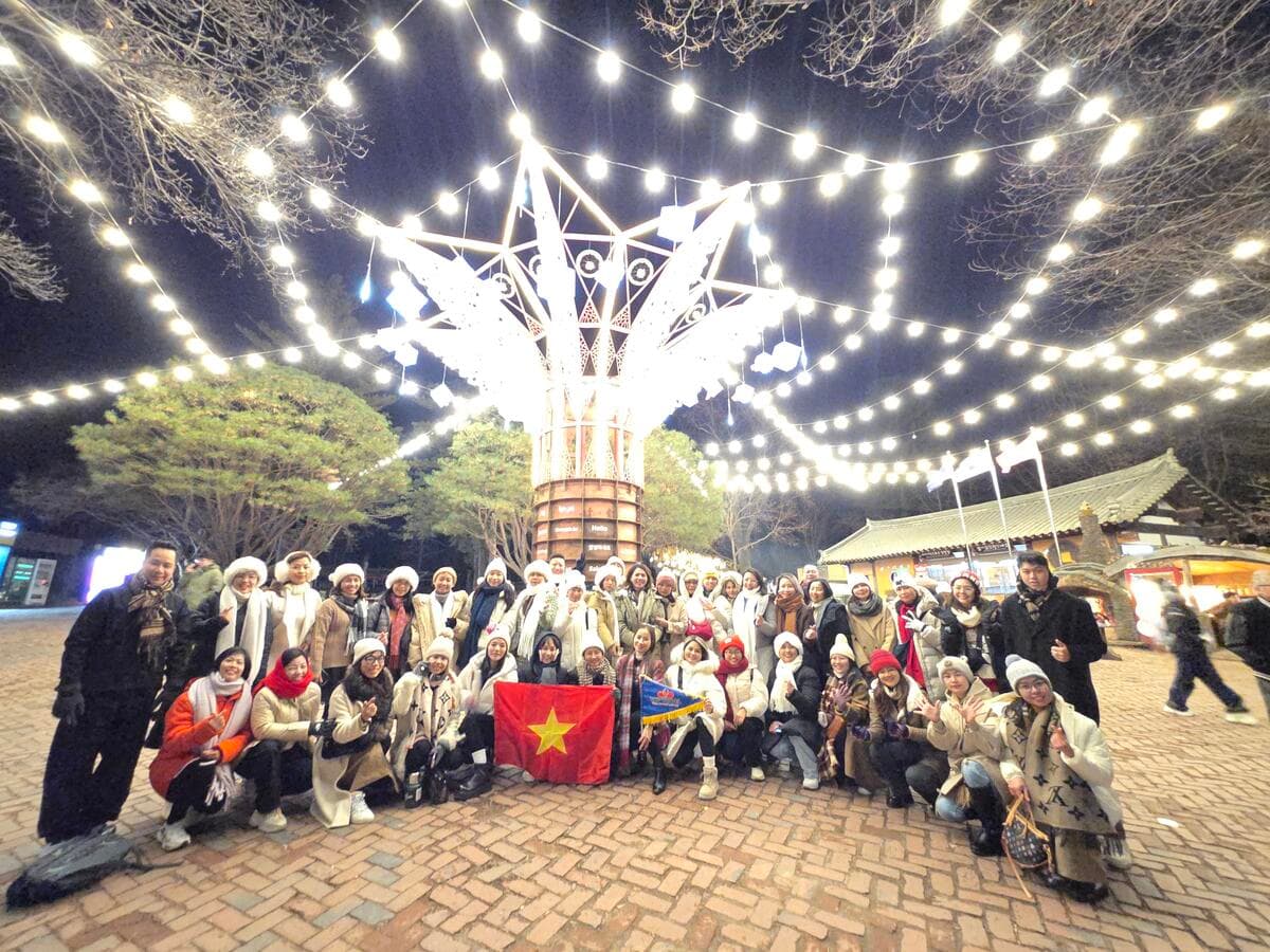 A group photograph beneath the outdoor lights.